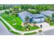 Aerial shot showcasing a single Gathering home with a two-car garage and lush lawns next to a pond at 12755 Rainwashed Loop, Parrish, FL 34219