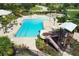 Aerial view highlighting community pool with water slide, splash pad, and proximity to neighborhood amenities and lush landscapes at 12755 Rainwashed Loop, Parrish, FL 34219