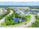 Wide aerial view showcasing a community with lakes, ponds, and manicured landscaping at 12755 Rainwashed Loop, Parrish, FL 34219