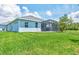 Lush backyard featuring a screened-in patio and well-maintained lawn at 12755 Rainwashed Loop, Parrish, FL 34219