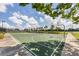 Well-maintained outdoor basketball court surrounded by lush landscaping, offering a great recreational space for residents at 12755 Rainwashed Loop, Parrish, FL 34219