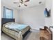 Cozy bedroom features a ceiling fan, natural light, and a mounted TV at 12755 Rainwashed Loop, Parrish, FL 34219
