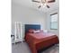 Carpeted bedroom with ceiling fan, a mirror, and a window at 12755 Rainwashed Loop, Parrish, FL 34219