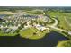 Aerial view of community with lake, community pool, and surrounding homes at 12755 Rainwashed Loop, Parrish, FL 34219