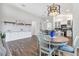 Well-lit dining area showcases tile floors, modern lighting, and built in cabinets with a view of the kitchen at 12755 Rainwashed Loop, Parrish, FL 34219