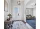 Inviting entryway featuring a decorative front door, chandelier, and a view into a living room at 12755 Rainwashed Loop, Parrish, FL 34219