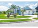 Charming single-Gathering home featuring a two-car garage and a well-maintained lawn with decorative landscaping and palm trees at 12755 Rainwashed Loop, Parrish, FL 34219