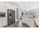 Modern kitchen with white cabinetry, stainless steel appliances, and a convenient pantry, perfect for culinary enthusiasts at 12755 Rainwashed Loop, Parrish, FL 34219