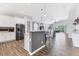 Bright and open kitchen with an island, modern finishes, and a seamless flow to the living and dining areas at 12755 Rainwashed Loop, Parrish, FL 34219