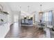 Bright kitchen features a center island, modern pendant lighting, light cabinetry, and adjacent dining area at 12755 Rainwashed Loop, Parrish, FL 34219