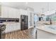 Contemporary kitchen featuring white cabinets, stainless steel appliances, and a spacious pantry for ample storage at 12755 Rainwashed Loop, Parrish, FL 34219