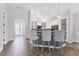 Open-concept kitchen with a large island, seating, stainless steel appliances, and stylish finishes for modern living at 12755 Rainwashed Loop, Parrish, FL 34219