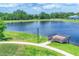 Aerial view of community lake with pier, landscaping, and walking path at 12755 Rainwashed Loop, Parrish, FL 34219