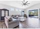 Bright and airy living room with vaulted ceilings, wood-look tile floors, and a seamless transition to outdoor living at 12755 Rainwashed Loop, Parrish, FL 34219