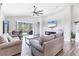 Comfortable living room features wood-look tile floors, a stone fireplace, and sliding glass doors for indoor-outdoor living at 12755 Rainwashed Loop, Parrish, FL 34219