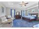 Spacious main bedroom with tray ceiling, carpeted floor, ceiling fan, and matching furniture set at 12755 Rainwashed Loop, Parrish, FL 34219
