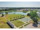Community park with basketball court, lake, pier, and manicured landscaping at 12755 Rainwashed Loop, Parrish, FL 34219