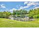 Scenic view of a serene pond surrounded by lush greenery and trees at 12755 Rainwashed Loop, Parrish, FL 34219