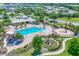 Aerial view of community pool, clubhouse, playground, and sand volleyball court at 12755 Rainwashed Loop, Parrish, FL 34219