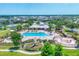 Aerial view of community pool, clubhouse, playground, and sand volleyball court at 12755 Rainwashed Loop, Parrish, FL 34219