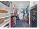 Walk-in closet with white shelving, clothing racks, carpeting, and a safe at 12755 Rainwashed Loop, Parrish, FL 34219