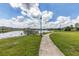 Scenic community walking path by a tranquil lake, perfect for leisurely strolls and enjoying nature at 12755 Rainwashed Loop, Parrish, FL 34219