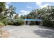 Charming single-story home with a carport and lush landscaping at 129 Pierson Ln, Sarasota, FL 34242