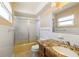 Well-lit bathroom with a granite-topped vanity, toilet, and a shower with glass door at 135 Gulfview Rd, Punta Gorda, FL 33950