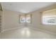 Well lit bedroom shows multiple windows with neutral walls and floors at 135 Gulfview Rd, Punta Gorda, FL 33950