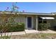 Charming front entrance with colorful flowers, bushes, and a vibrant front door at 135 Gulfview Rd, Punta Gorda, FL 33950