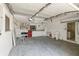 Spacious two-car garage with ample storage, tool racks, work table, and washer dryer hookups at 135 Gulfview Rd, Punta Gorda, FL 33950