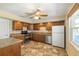 Well-lit kitchen with granite counters, modern stainless steel appliances, ample cabinet space, and tile flooring at 135 Gulfview Rd, Punta Gorda, FL 33950