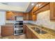 This kitchen features granite countertops, wooden cabinets, updated stainless steel appliances, and designer backsplash at 135 Gulfview Rd, Punta Gorda, FL 33950