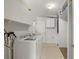 Bright laundry room with modern appliances, storage, and overhead lighting at 135 Gulfview Rd, Punta Gorda, FL 33950