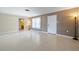 Inviting living room boasts neutral tones, a large window for natural light, and smooth floors at 135 Gulfview Rd, Punta Gorda, FL 33950