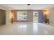 Bright living room featuring terrazzo flooring, natural light, and a view of the outdoors at 135 Gulfview Rd, Punta Gorda, FL 33950