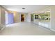 Spacious living room featuring neutral walls, large windows, and access to other areas at 135 Gulfview Rd, Punta Gorda, FL 33950