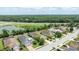 Aerial view showcasing neighborhood homes near highway and lake at 13819 American Prairie Pl, Bradenton, FL 34211