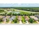 An aerial view features a home, a pond, and lush green spaces in a neighborhood at 13819 American Prairie Pl, Bradenton, FL 34211