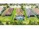 Aerial view showing a home with a screened-in pool, surrounded by green lawn and landscaping at 13819 American Prairie Pl, Bradenton, FL 34211