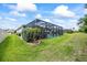 Backyard view featuring a private screened-in pool and lush green lawn at 13819 American Prairie Pl, Bradenton, FL 34211