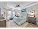 Spacious bedroom with tray ceiling, plush bedding, and a ceiling fan at 13819 American Prairie Pl, Bradenton, FL 34211