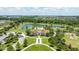 Aerial view featuring a community clubhouse with a pool and surrounding recreational area and lake at 13819 American Prairie Pl, Bradenton, FL 34211