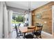 Eat-in dining area with wood-accent wall and sliding glass doors leading to the pool at 13819 American Prairie Pl, Bradenton, FL 34211