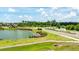 Landscaped entrance to the Savanna neighborhood with community signage, a scenic pond, and a lush green lawn at 13819 American Prairie Pl, Bradenton, FL 34211