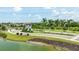 Scenic neighborhood entrance with a decorative gatehouse, lush greenery, and views of the surrounding community pond at 13819 American Prairie Pl, Bradenton, FL 34211