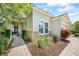 Home exterior displaying a stone accent wall, brick walkway, and beautiful landscaping at 13819 American Prairie Pl, Bradenton, FL 34211