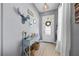 Entryway features a decorative console table, decor, and a view of the front door at 13819 American Prairie Pl, Bradenton, FL 34211
