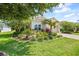 Charming single-story home with lush landscaping and a well-manicured lawn at 13819 American Prairie Pl, Bradenton, FL 34211