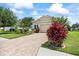Beautiful home featuring a brick driveway and vibrant, well-maintained landscaping at 13819 American Prairie Pl, Bradenton, FL 34211